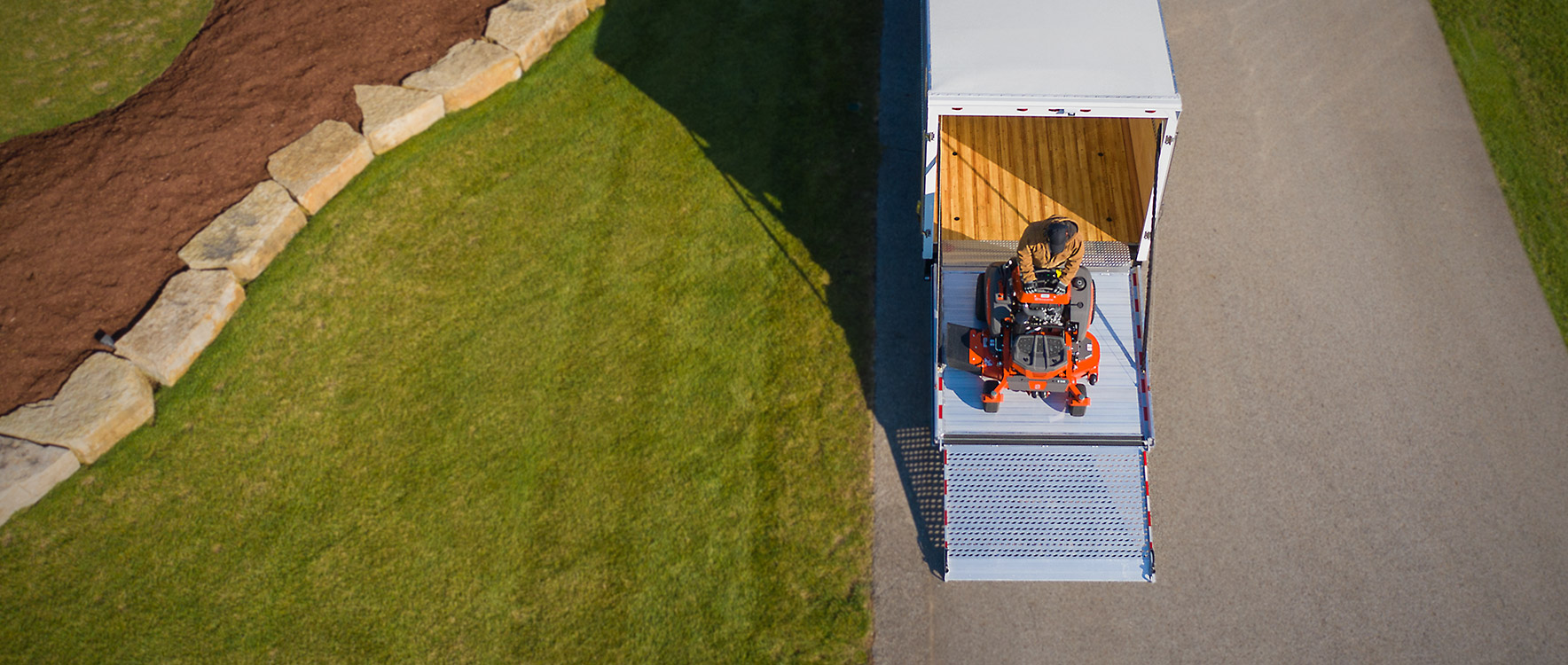 Dry Freight Proscape-Van driving mower down ramp door