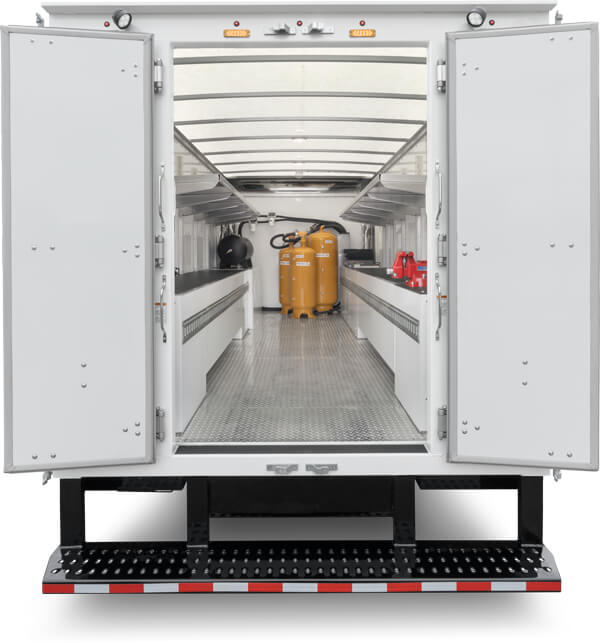 WorkPro commercial work truck with back doors open showing inside workbenches and storage